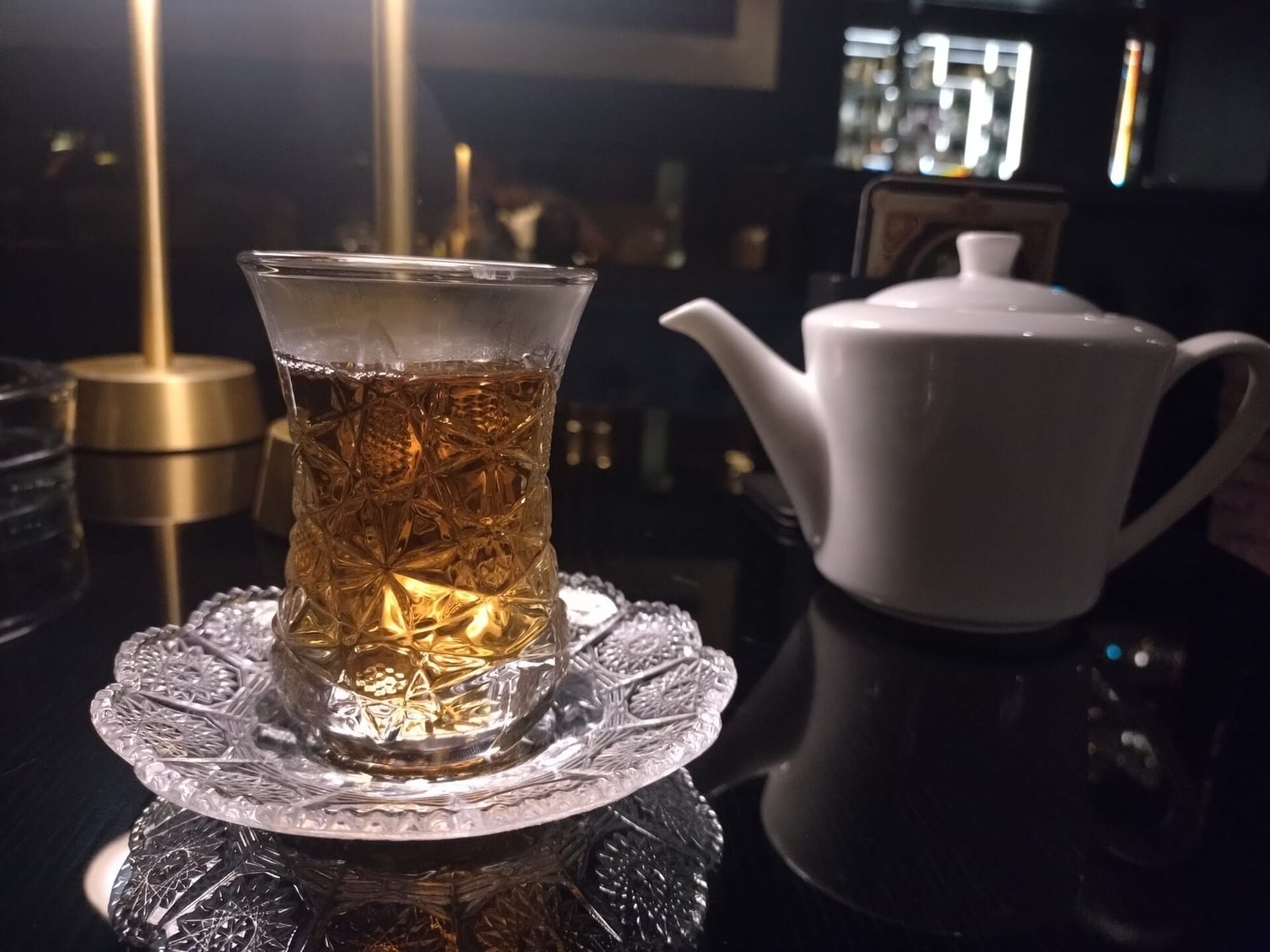 Nəlbəki üstündə armudu stəkanda çay və ağ çaydan